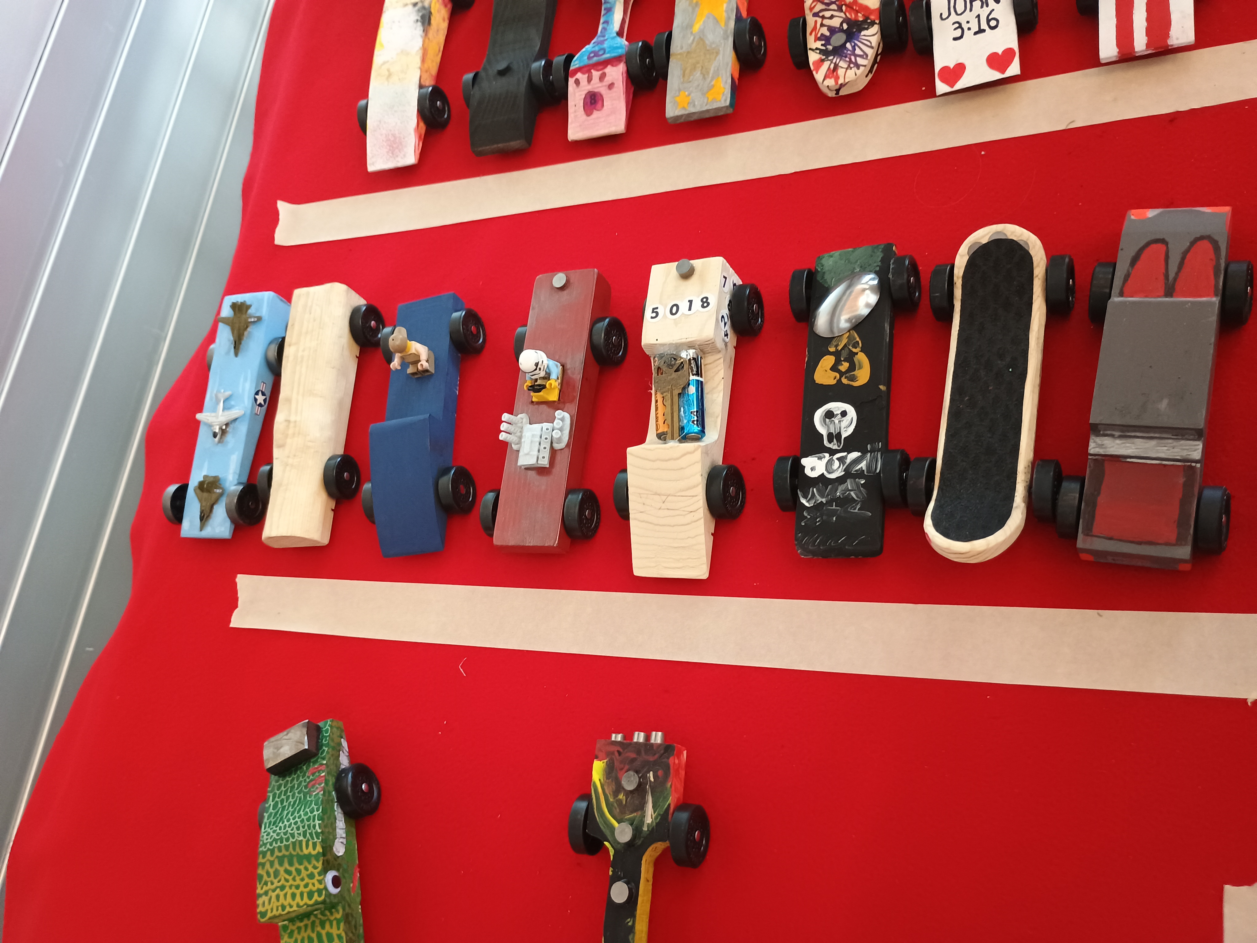 Pack 62 Pinewood Derby cars on display
